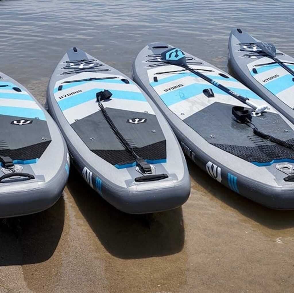 Four Hydrus paddle boards in a row